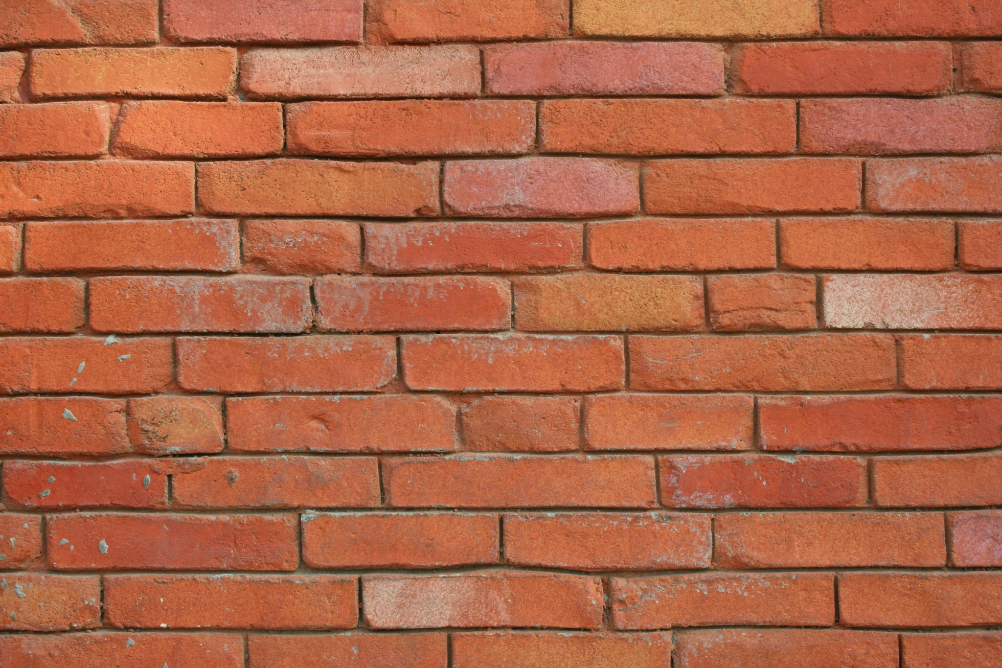 A stack of raw bricks ready for use, highlighting the traditional option in the debate of concrete blocks vs brick walls for retaining wall construction.