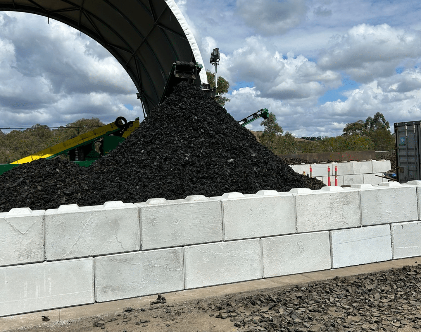Large pile of recycled concrete blocks used for retaining walls in a storage yard
