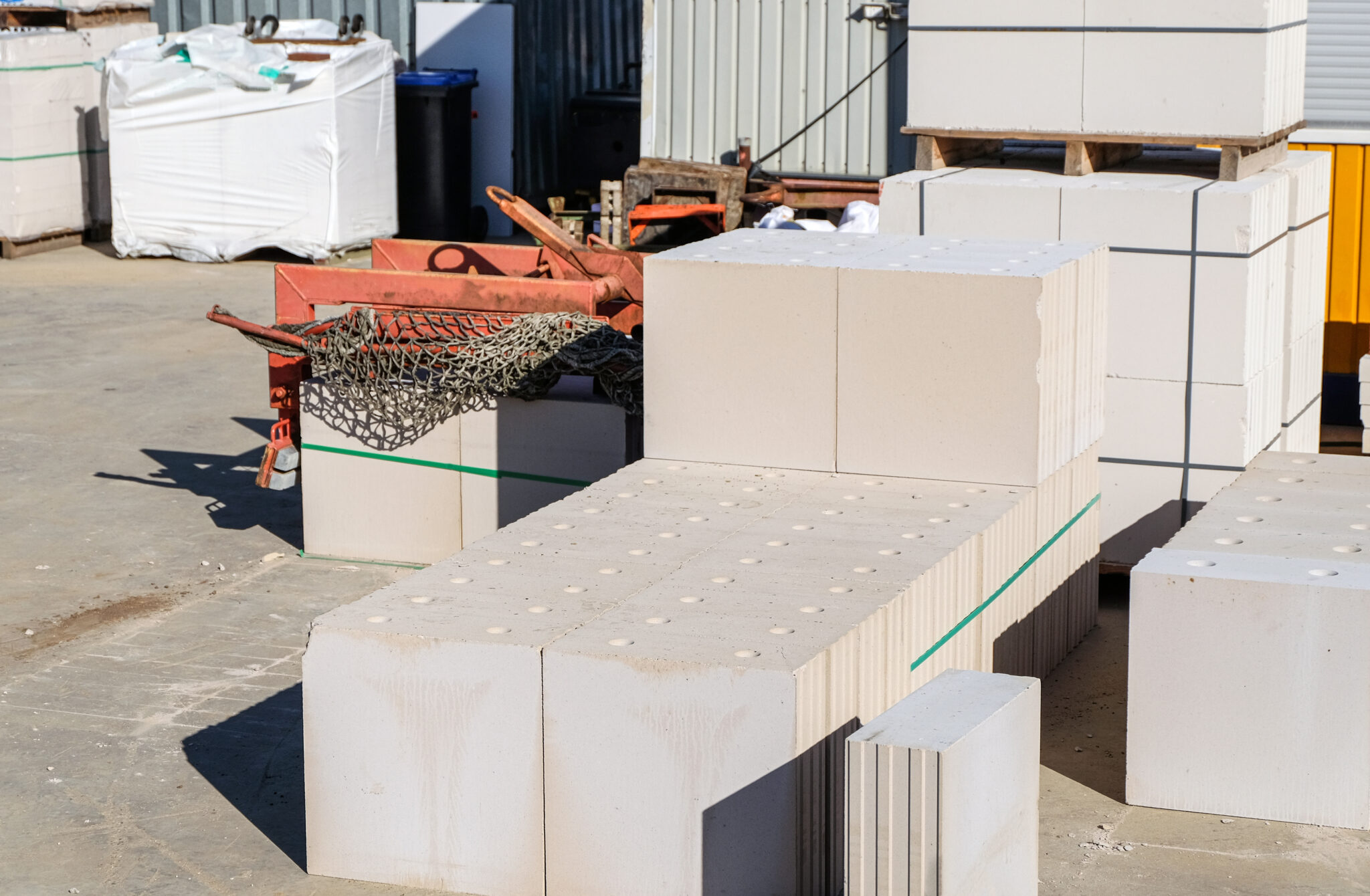 White aerated concrete blocks stacked at a construction site, representing materials used in precast concrete in fire-resistant construction for durability and safety