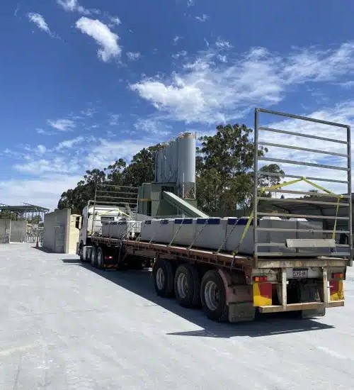 Industrial truck transporting precast concrete blocks, illustrating efficiency and busting precast concrete myths.