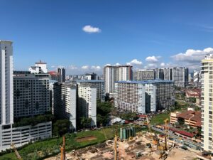 Aerial view of high-rise buildings and active precast concrete construction site on the Gold Coast under a clear blue sky.