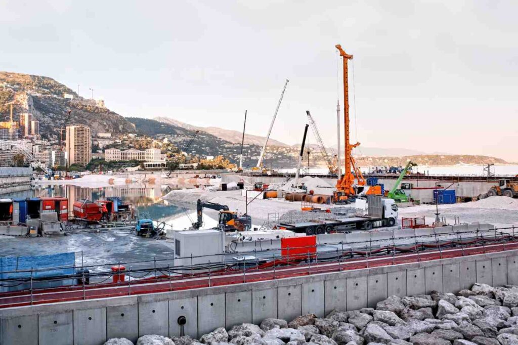 Harbour development site on the Gold Coast featuring cranes and heavy equipment using sustainable construction materials for marine infrastructure.