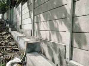 Concrete sleeper retaining wall construction requiring council approval on a sloped property in the Gold Coast