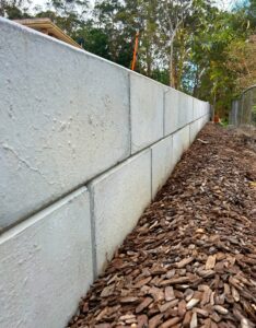 Concrete block retaining wall showing early signs of structural issues linked to retaining wall failures Gold Coast