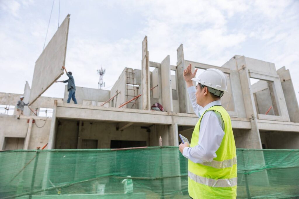 Construction supervisor managing precast concrete installation on the Gold Coast during summer building season