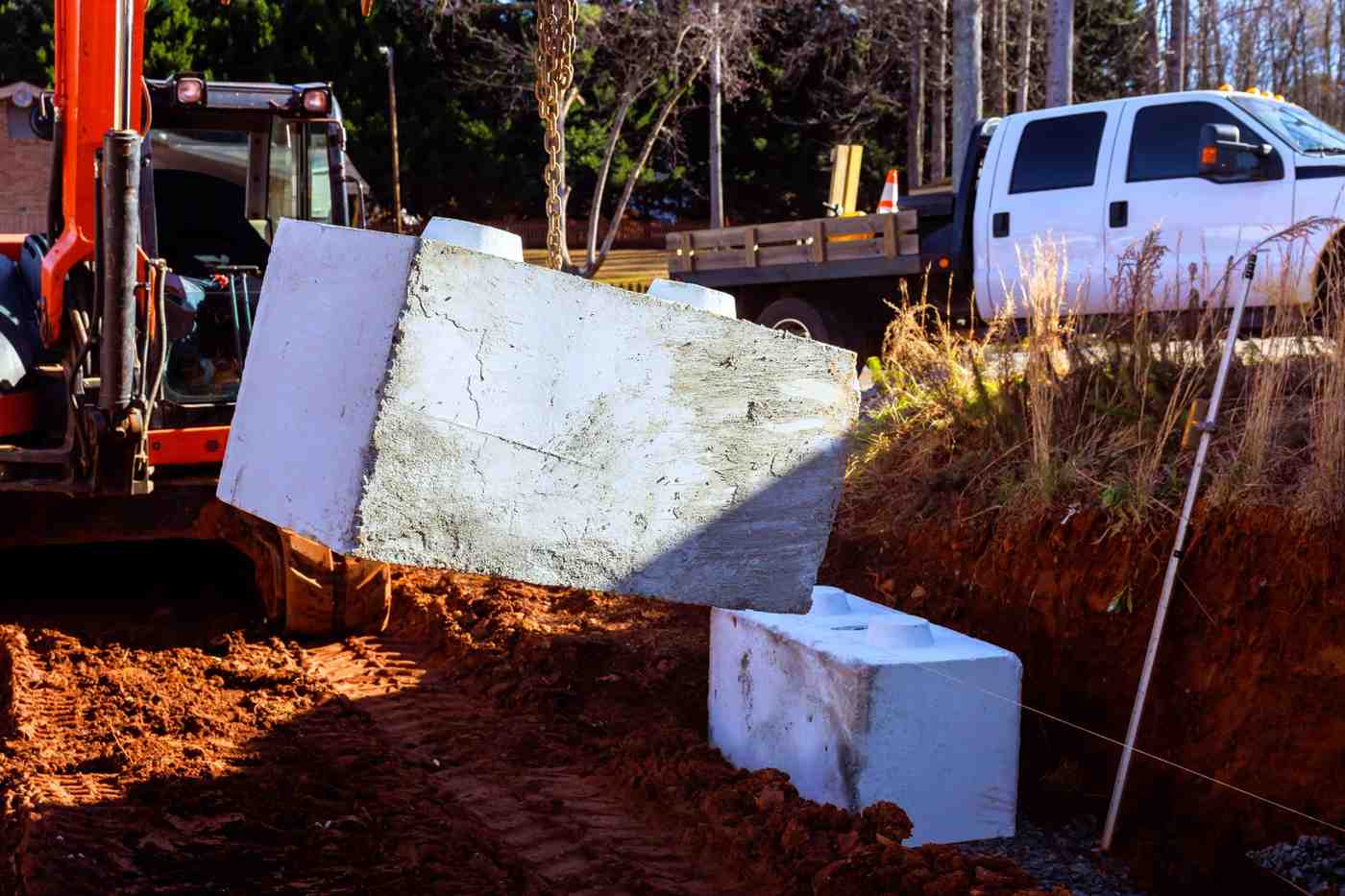 Wet season retaining wall prep showing precast block installation during retaining wall build 