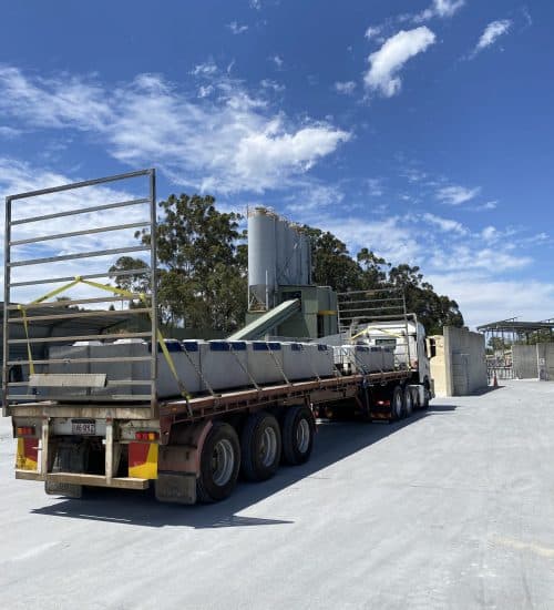 Large interlocking blocks for flood-prone areas loaded on a truck for transport and installation at a construction site