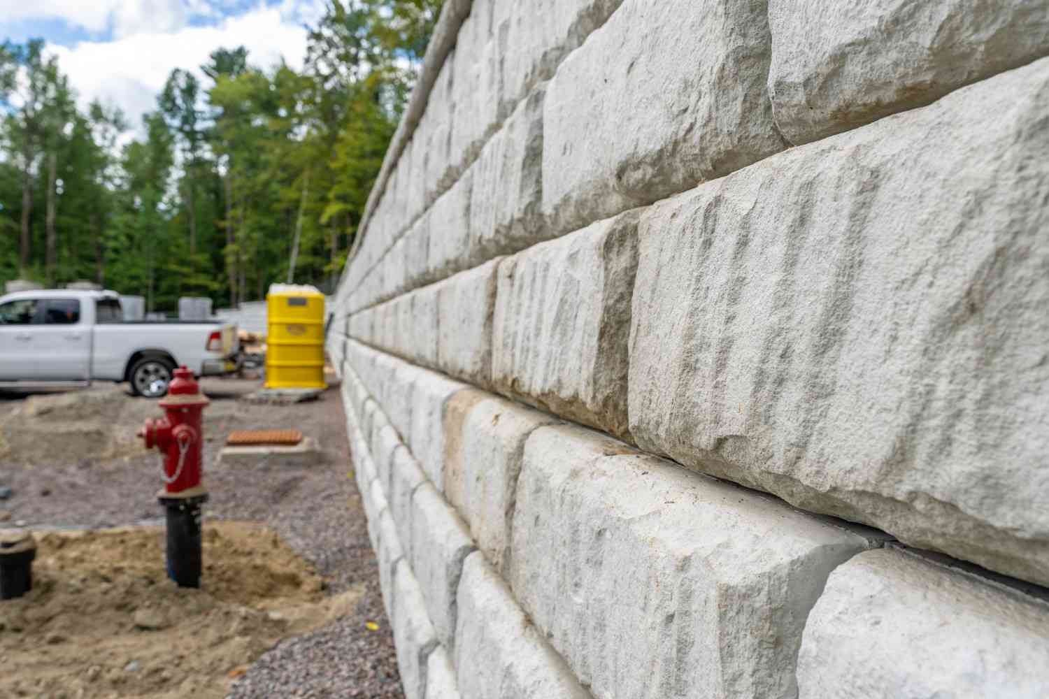 Close-up of stone retaining wall construction aligned with commercial retaining wall compliance in QLD