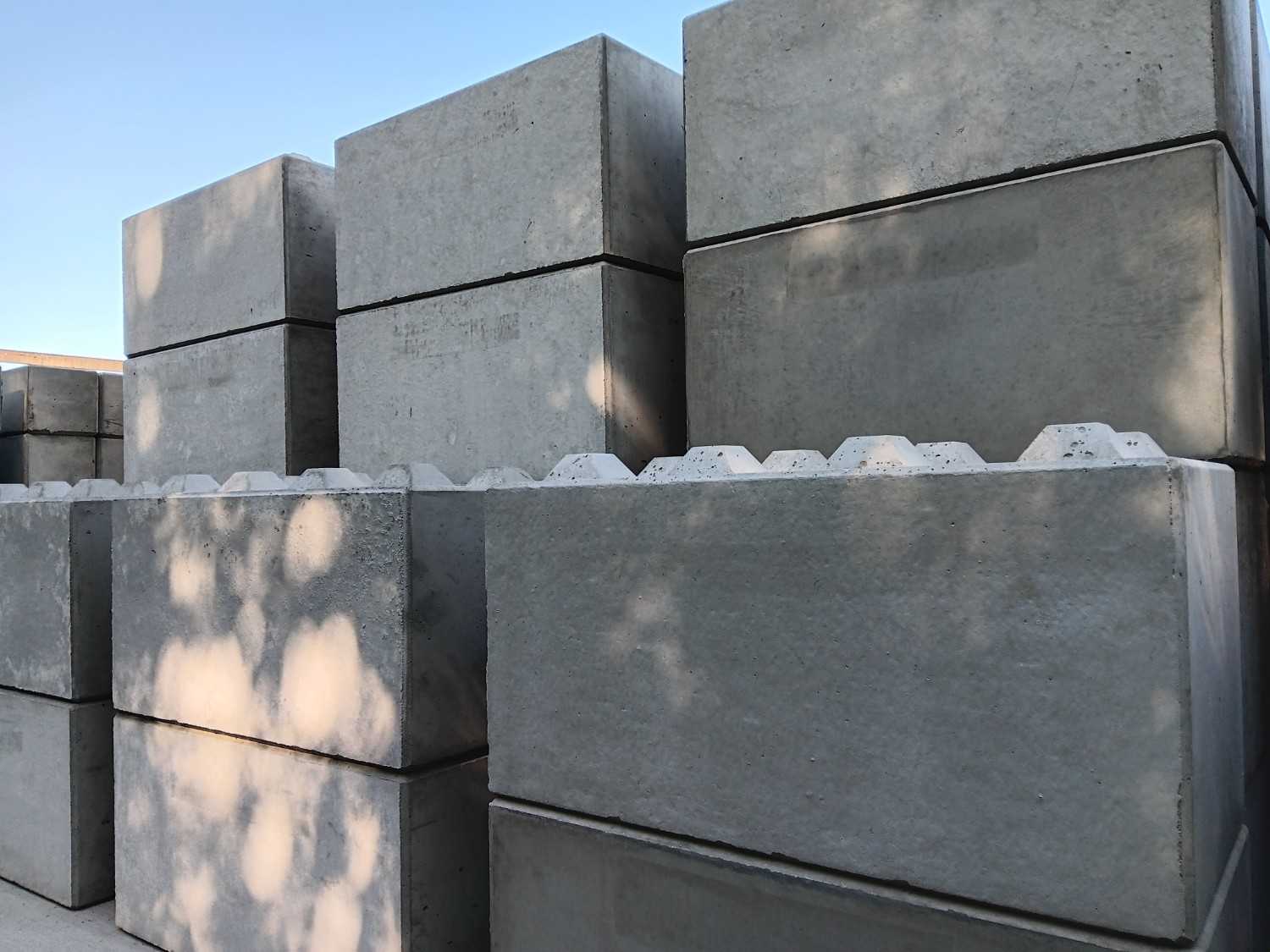 Precast concrete supply Gold Coast featuring large concrete barrier blocks stacked for construction use