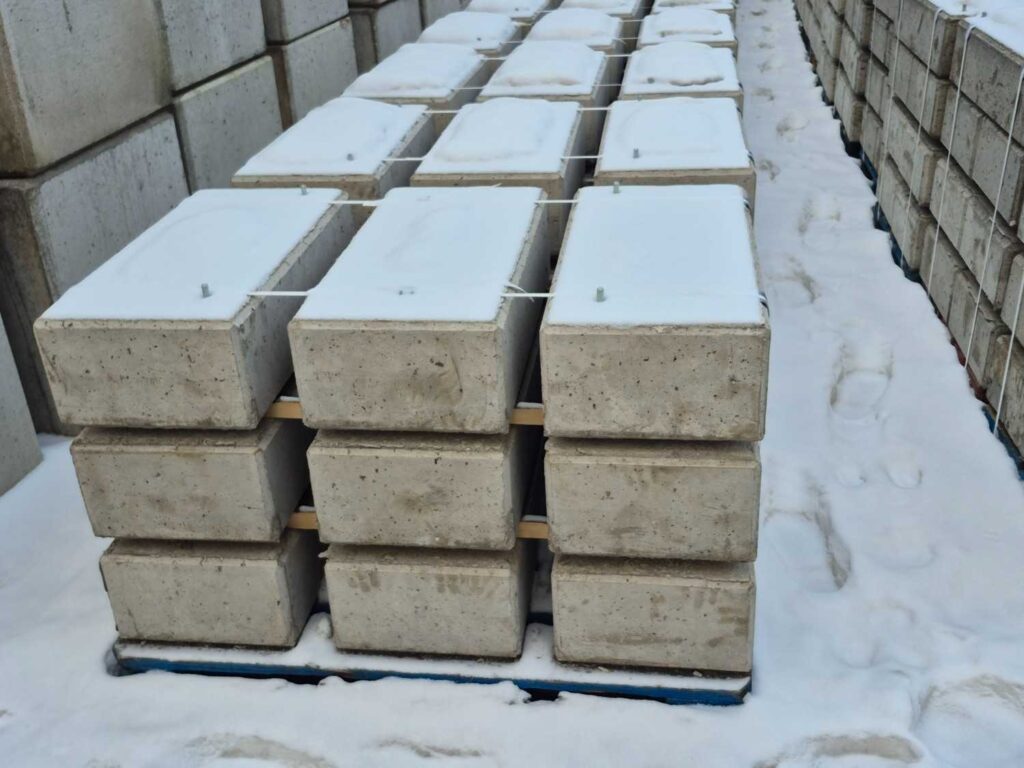 Precast concrete supply Gold Coast with stacked concrete blocks stored outdoors in a snowy yard