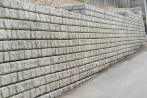 Stacked stone retaining wall showing common retaining wall design mistakes to avoid in residential landscaping