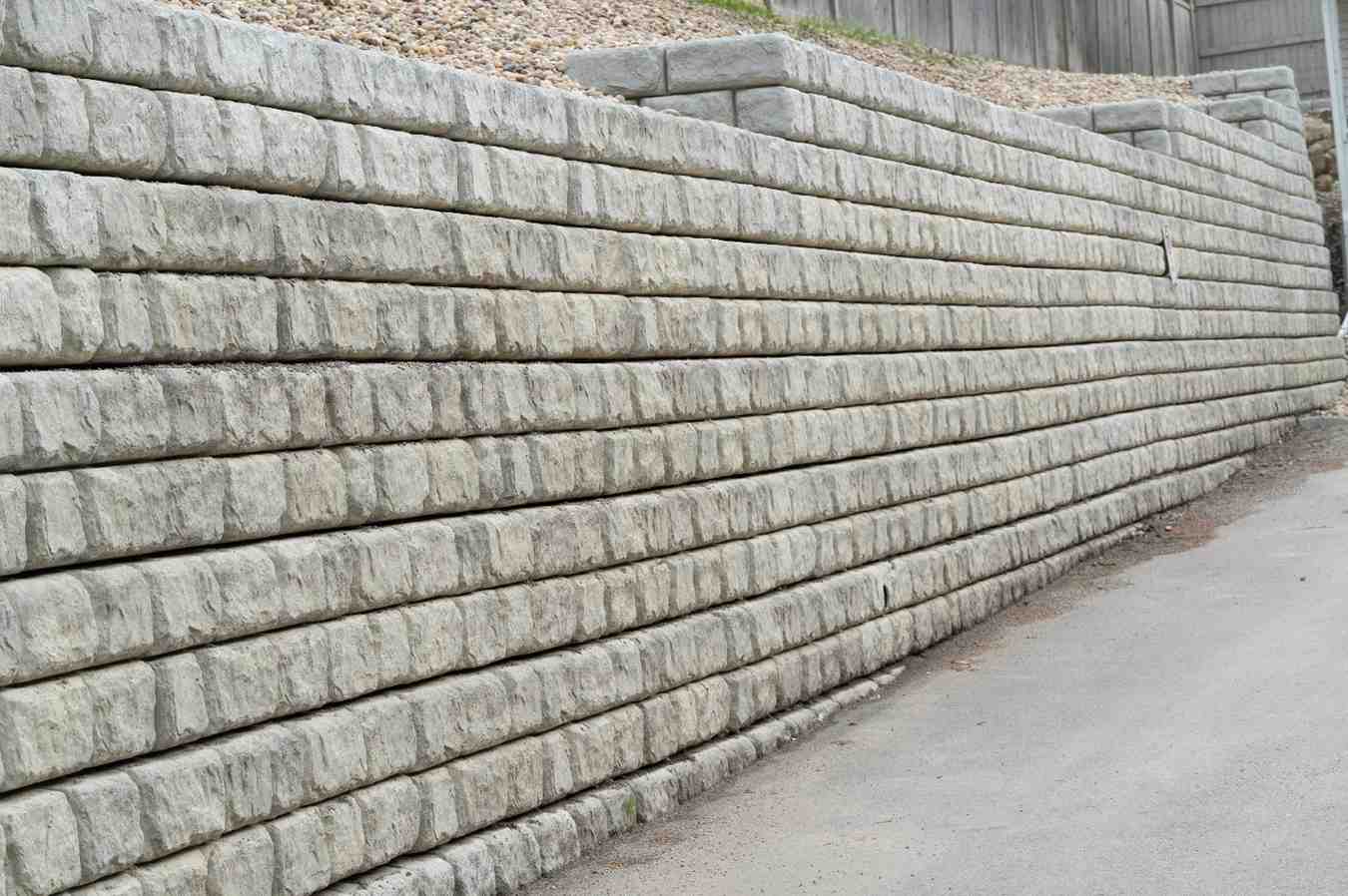 Stacked stone retaining wall showing common retaining wall design mistakes to avoid in residential landscaping