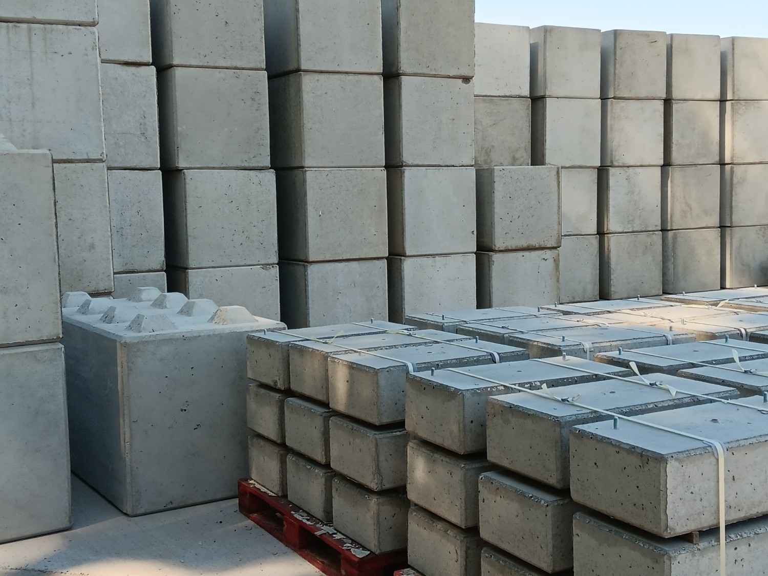 Large interlocking concrete blocks with lifting hooks positioned on a commercial site in Queensland