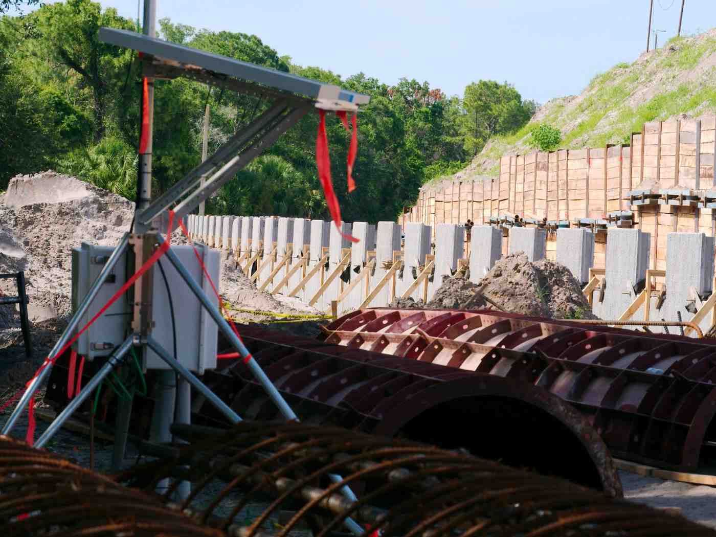 Precast concrete retaining wall under construction on a Gold Coast civil and infrastructure site, with earthworks and drainage works alongside