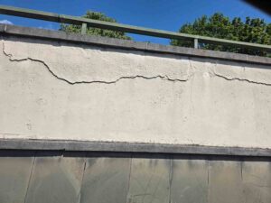 A concrete retaining wall with visible cracking that needs retaining wall repair
